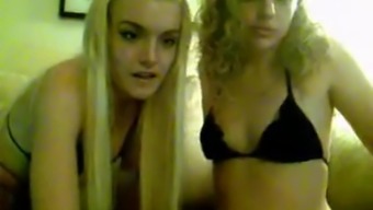 Horny lesbians rub pussies on cam