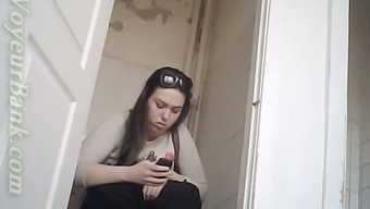 Chunky white brunette lady texting and pissing in the toilet