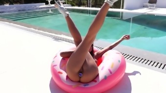 Tempting tanned babe with jewel plug in her anus Maria masturbates pussy by the pool side