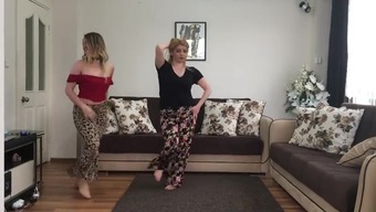 Two blonde girls dancing at home