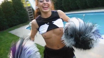 A cute cheerleader flashes her tits while in her uniform