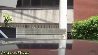 Spying on a cute Asian chick as she pees in public