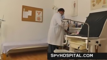 Mature gyno medical professional operates a concealed cam