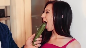 A girl with a sexy ass is getting a cucumber inside her pussy