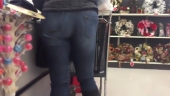 Sexy ebony in tight blue jeans candid in store
