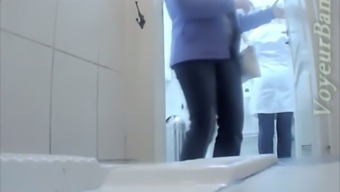 Chubby mature white woman in the public restroom on spycam video