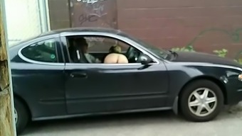 Naked hooker gives blowjob in the car and gets filmed