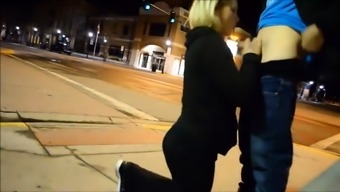 Busty exhibitionist sucking cock in the city street by night