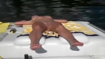 Naked woman sleeps on the boat as he films