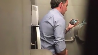 Stranger man in a public toilet filmed on a hidden camera
