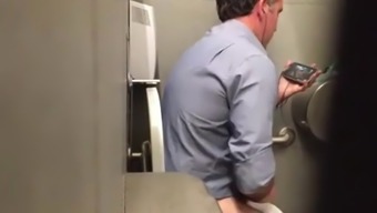 Stranger man in a public toilet filmed on a hidden camera