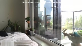 Hot neighbor girl gives blowjob in front of window