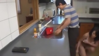 son plays with mom in the kitchen and dad almost caught them