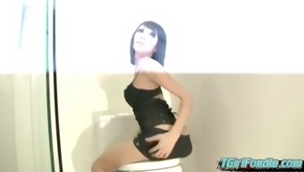 Short haired ladyboy sits on toilet and sucks big cock cum