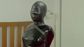 Redhead in Latex Suit getting Tied Up in Hood, Armbinder, and Bodybag
