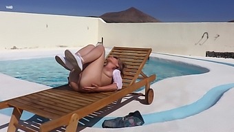 Sexy blonde Angel B strips and plays with her pussy by the pool
