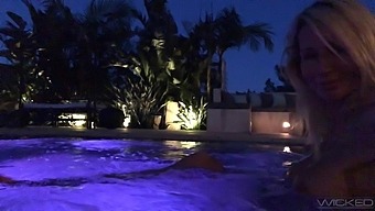 Torrid auburn Jessica Drake flashes her boobies in the pool at night
