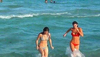 Two lesbians are looking to have a fun and swim in the ocean
