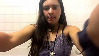 Stacked teen fingering her hairy pussy in a public toilet