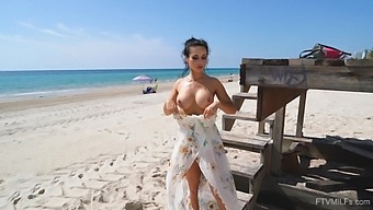 Horny MILF Crystal flashes her big breasts on the beach