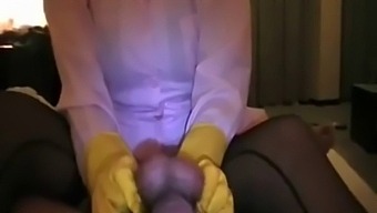 Asian nurse in yellow rubber gloves jerks off