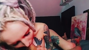 Tattooed slut squeezes cum out of a big dick with her feet