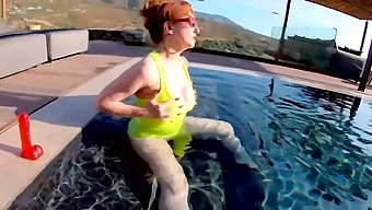 Red XXX fucks her pussy with a toy in the pool
