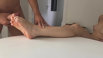 Horny Girlfriend Gives Footjob On The Table For A Huge Cumshot