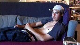 This 21-year-old skater is reclining on the couch and rubbing his bulge through some rather heavy jeans, and then unzipping through the fly of his boxers. Getting stiffer, Mark shows off his beautiful boner while looking at the camera.