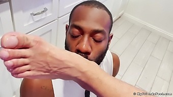 Foot fetish video of a horny black dude licking his lover's feet