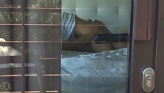 Filming a hot couple having sex while looking out the hotel window