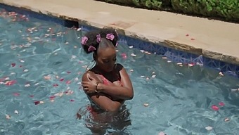 Elsie, the ebony beauty, strips down for the camera in a poolside solo session