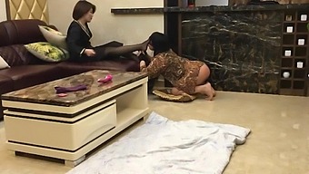 Asian femdom in stockings humiliates crossdresser with toy