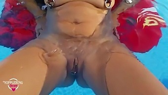 HD video of a blonde MILF swimming and showing off her big nipples and pierced pussy