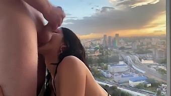 Amateur brunette gives a sloppy blowjob and cumshot on balcony