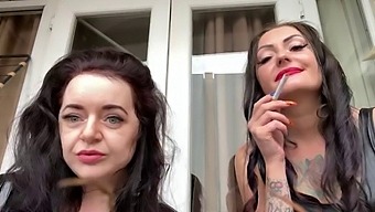 Latex-clad Mistress Lara and Dominatrix Nika indulge in smoking and vaping fetish