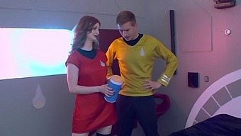 Two busty redheads pleasure each other in a futuristic threesome