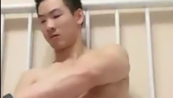 Muscular Asian guy strokes himself to orgasm